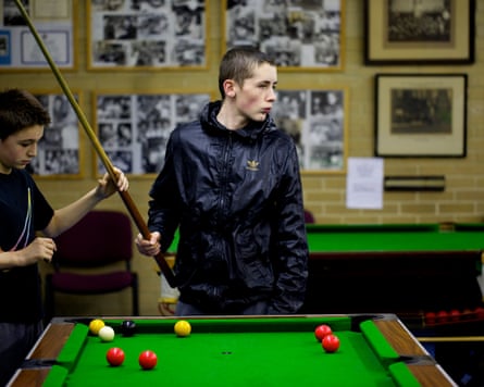 Two boys playing snooker in a youth club