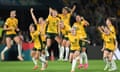 Australia players jump into the air and shout in celebration after France miss a penalty