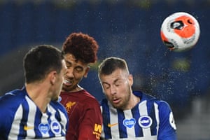 Liverpool’s Roberto Firmino betas Brighton’s Adam Webster (right) and Lewis Dunk to a header.