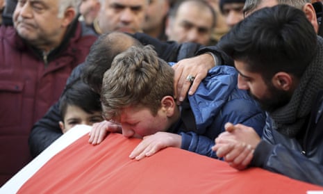 Family members and friends mourn as they attend funeral prayers for Ayhan Akin, one of the nightclub victims, in Istanbul