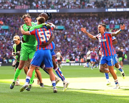Justin Devenny of Crystal Palace celebrates with teammates after he scores the winning penalty.