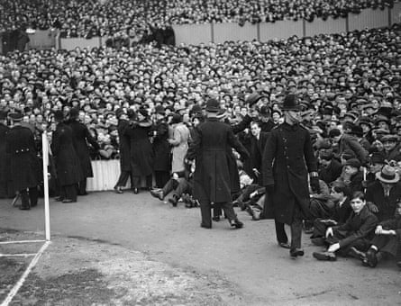 Police control a crowd of 71,913 at White Hart Lane during the FA Cup quarter-final between the sides in 1937. Preston won and went on to lose to Sunderland in the final.