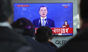 People watch a live broadcast of South Korean President Moon Jae-in.