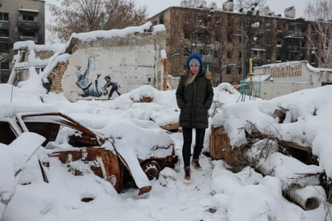 A eoman seen near an artwork by British street artist Banksy on 7 December in Borodyanka, Ukraine.