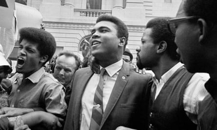 Muhammad Ali leaves the Huston armed forces induction centre with his entourage after refusing to be drafted in 1967.