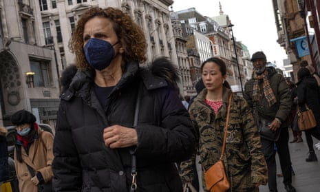 A woman wears a face mask on Oxford Street, London.
