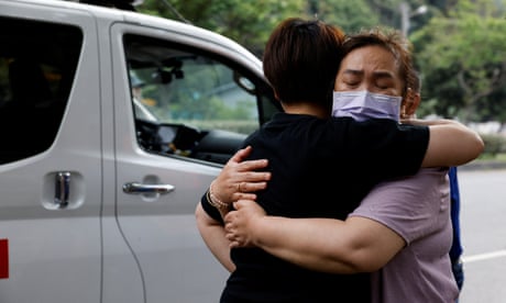 Relatives hug as they are reunited after the earthquake in Hualien