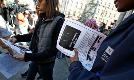 A New York City Health department official hands out information on the Ebola virus outside a school in the Bronx, New York .