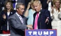 Trump shakes hands with Farage as he steps on to the podium to speak at a rally