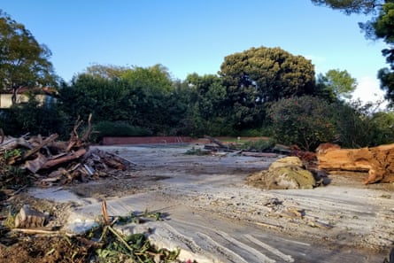 A completely flat area that has obviously been razed, surrounded by trees.