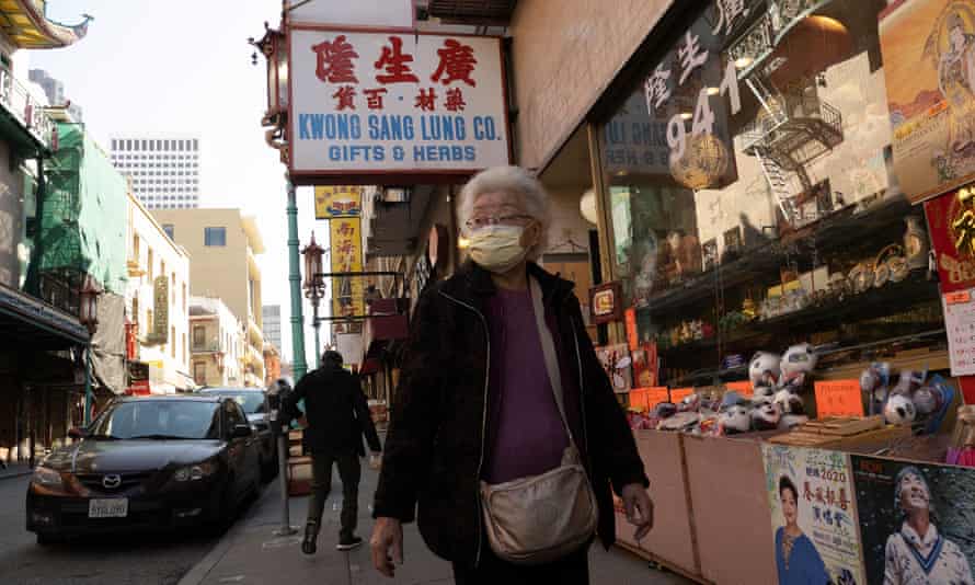 A woman walks through Chinatown while wearing a protective mask on Wednesday.