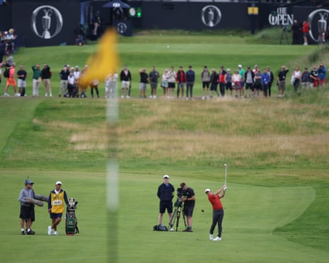 Rory McIlroy plays his approach shot from the first fairway