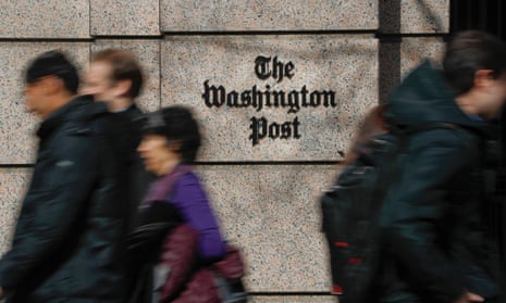 People walk by the One Franklin Square building, home of The Washington Post newspaper, in downtown Washington DC, 21 February 2019.