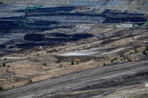 Excavators remove layers of earth to reach the lignite lying underneath the Turów open-pit mine