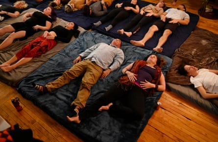 Sacred Tribe attendees stretch out during a breath work exercise after most took the sacrament, psilocybin mushrooms, at a Sacrament ceremony.