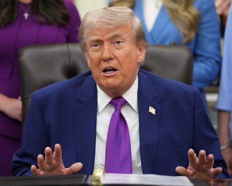Donald Trump speaks to reporters at an event about maternal healthcare in the Oval Office.