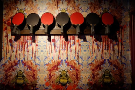 Bats in a rack behind reception at Bounce ping-pong Club