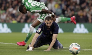 Real Madrid’s Karim Benzema sees the ball evade him after a tussle with Real Betis’ Emerson.