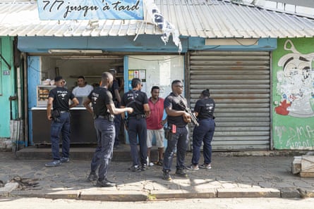 Officers from the Operation Support Group check people’s IDs in the streets of Mamoudzou, Mayotte island, 2 May 2023.
