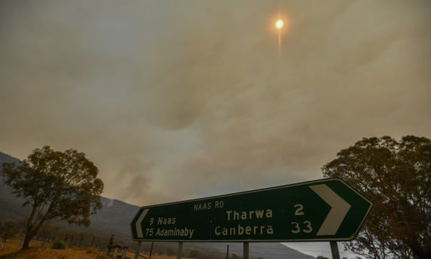 A bushfire burns behind a ridge near Tharwa Village, 30km south of Canberra.