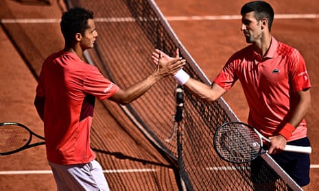 Serbia’s Novak Djokovic (R) shakes hands with Peru’s Juan Pablo Varillas after his victory during their men’s singles match