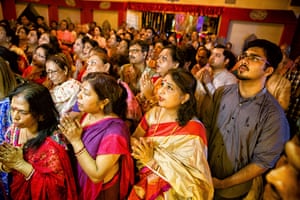 Devotees at a community Durga Puja praying on the eighth day of the festival. It is marked by a grand evening arati (ritual of invocation of the goddess), which is believed to be the most important day of the festival.
