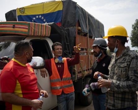 Volunteers, relatives of Guedez García’s family who travelled 700km to help, discuss the search operation