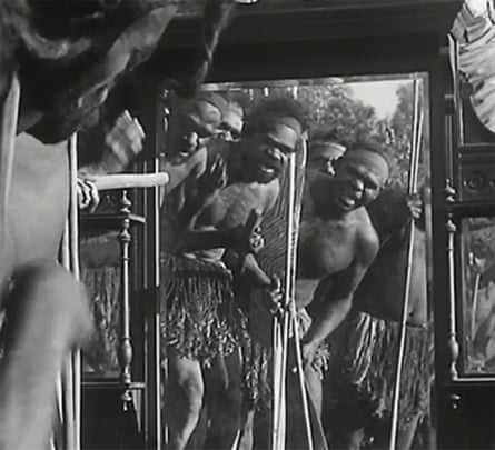 Aboriginal men peer through a window