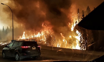 Raging … people flee the flames.