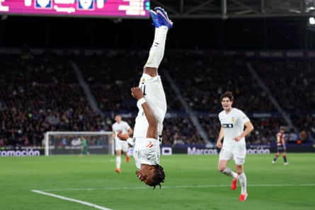 Valencia’s Largie Ramazani somersaults as he celebrates after scoring against Levante