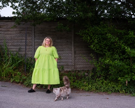 Rose Stokes in a lime green dress with her cat