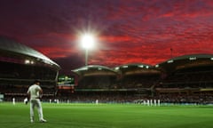 The lights come on under crimson skies as Adelaide Oval enters the first evening session in day-night Test cricket history.