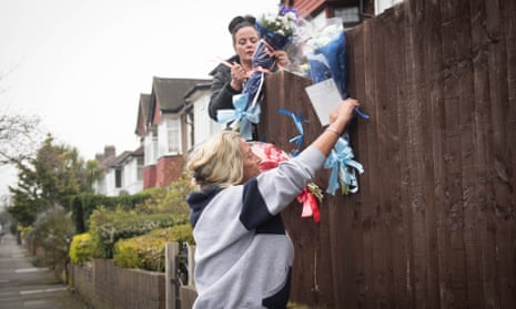 Friends and family of Henry Vincent attach flowers to a fence in Hither Green, near where he died.