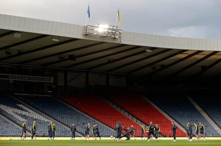 The Ukrainian players practice beneath the flag of Ukraine during a training session at Hampden Park.
