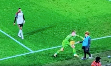Bernd Leno pushes a ballboy while trying to collect the ball during a break in play.