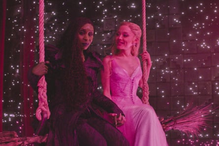 two women sit next to each other on a swing with pink-toned lighting and stars