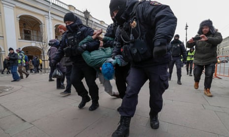 Russian police detain an anti-war protester in St.Petersburg.
