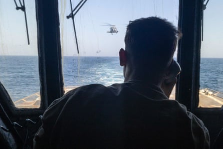 A sailor onboard USS Michael Murphy observing flight operations in the Arabian Sea.