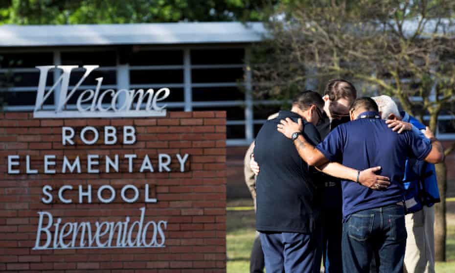 People gather at Robb elementary school, the scene of a mass shooting in Uvalde, Texas, Wednesday.