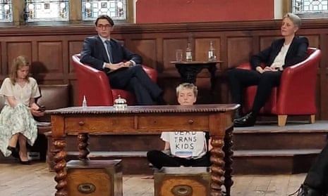 A trans activist glued their hands to the floor during the appearance by Kathleen Stock (top right) at the Oxford Union.