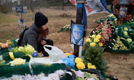 A young widow mourns at the grave of her deceased husband, a Ukrainian soldier who died during fighting with Russian occupying forces, on 8 January 2023 in Mykolaiv, Ukraine.