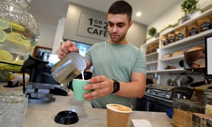 A barista is seen preparing a coffee at a cafe in Canberra