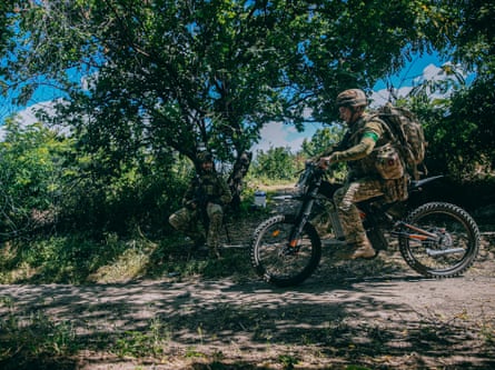 A soldier rides a scooter.