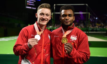 Silver medallist Nile Wilson (left) and gold medallist Courtney Tulloch following the gymnastics men’s rings final at the Commonwealth Games.