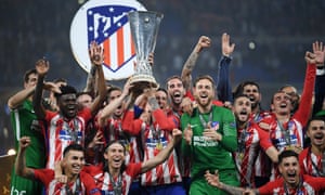 Atletico Madrid players lift the Europa League trophy.