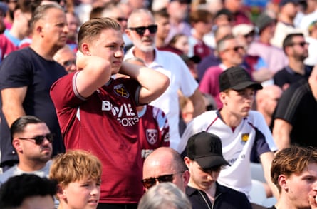 West Ham United fans react after finding out Tottenham Hotspur scored their side’s first goal of the game against Everton
