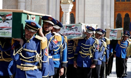 A Houthi guard of honour carries the coffins of those killed in the US-UK strikes.