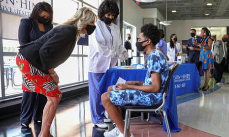U.S. first lady Jill Biden comforts a nervous patient at the coronavirus vaccination clinic at Jackson State University in Jackson, Mississippi.