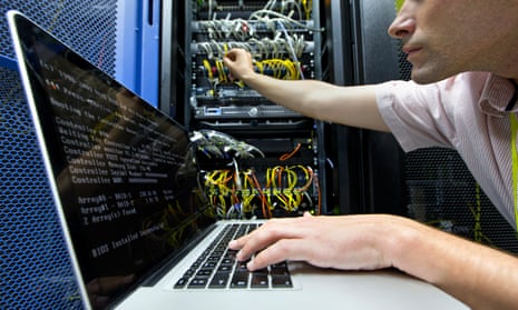 A technician checking a server in a data centre.
