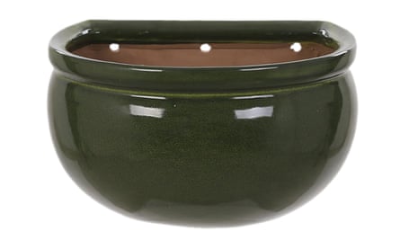 A dark green ceramic wall pot